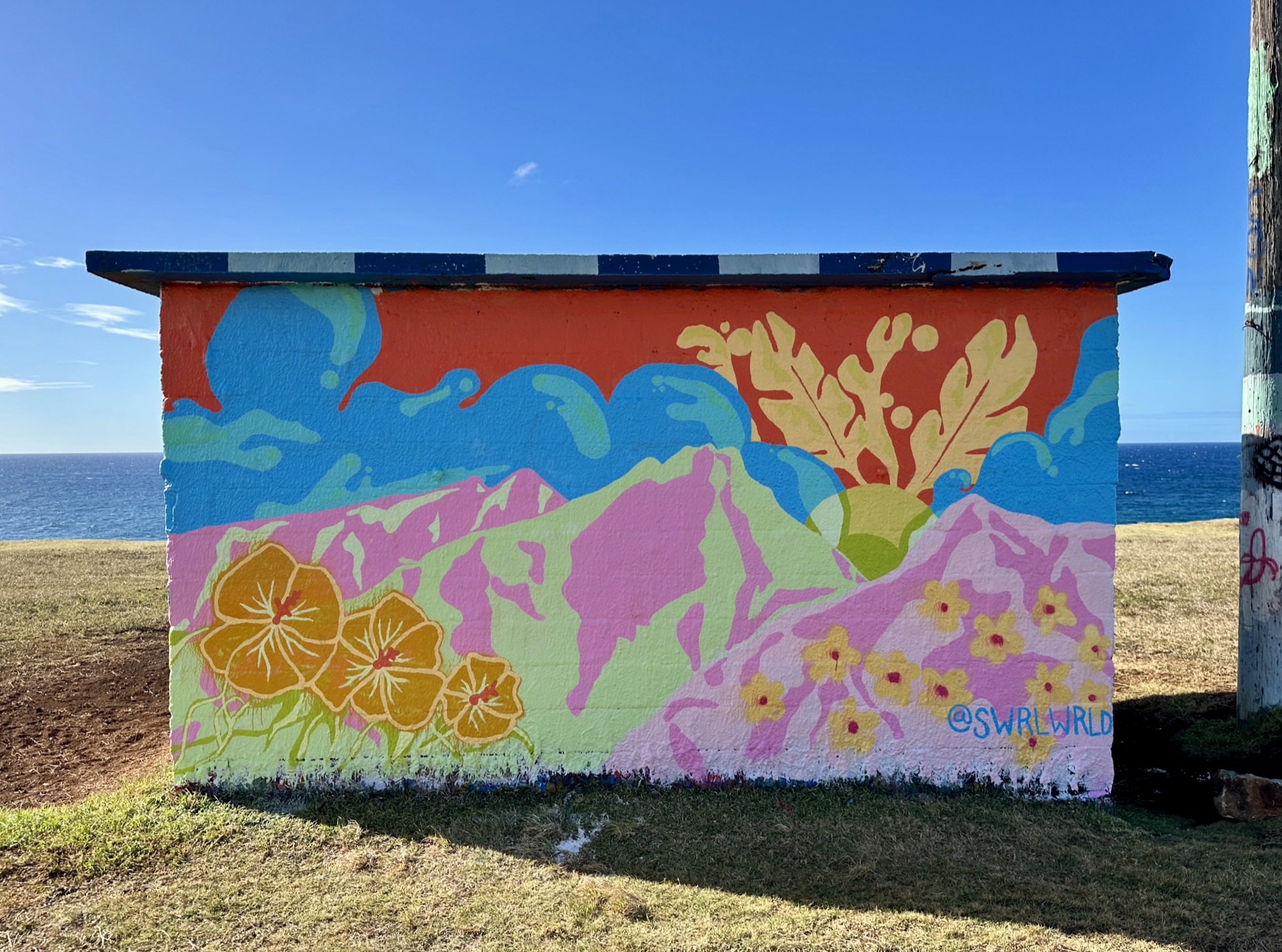 Colorful Maui mural with ocean backdrop